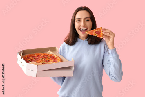 Young woman eating piece of...