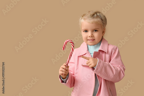 Cute little girl pointing a...