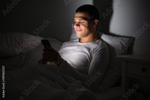 Young man using mobile phon...