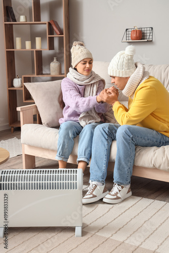 Young couple warming near r...