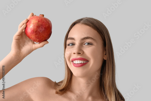 Young woman with pomegranat...