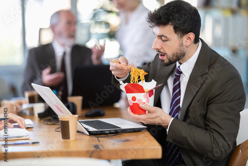 Photography Office staff are indignant because of unpleasant smell of food and resent for eating male colleague