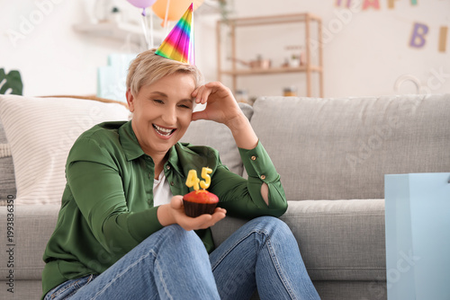 Happy mature woman with bir...