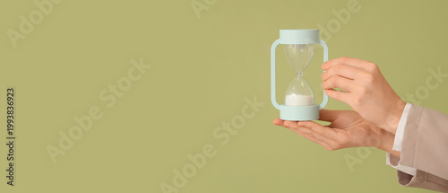 Female hands with hourglass...