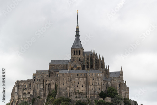 Obraz na plátně Mont Saint Michel abbey distant view with cloudy sky showing iconic historic Fre