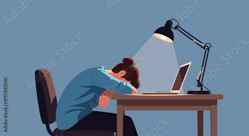Person sits at desk with head down on arms in front of laptop under lamp in a simple room during late hours of study