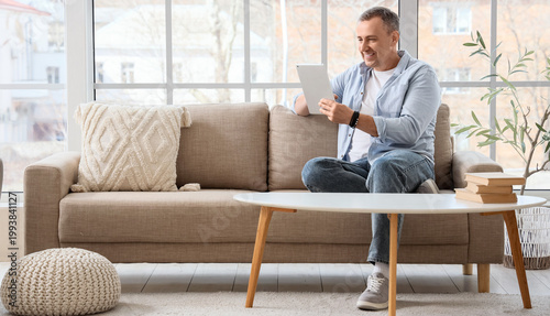 Mature man using tablet com...