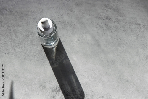 Skincare serum bottle on the grey background on grey background,