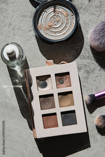 Makeup Palette and Brushes on Gray Surface