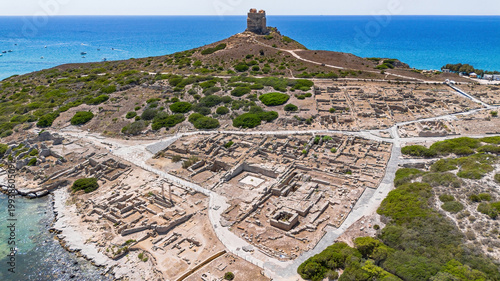 Aerial view of the ancient archaeological site of Tharros with Roman columns and ruins overlooking the sea, Sinis peninsula, Sardinia, Italy