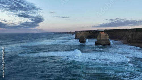 Twelve Apostles, Port Campbell National Park, Great Ocean Road, Victoria at sunrise: 4K aerial drone footage of limestone stacks, ocean waves, cliffs and coastal landscape in the morning.