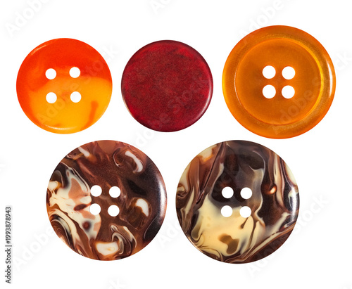 Isolated photo of orange and stone colored cloth buttons on white backdrop.
