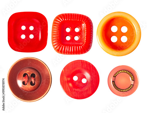 Isolated photo of orange and red colored cloth buttons on white backdrop.
