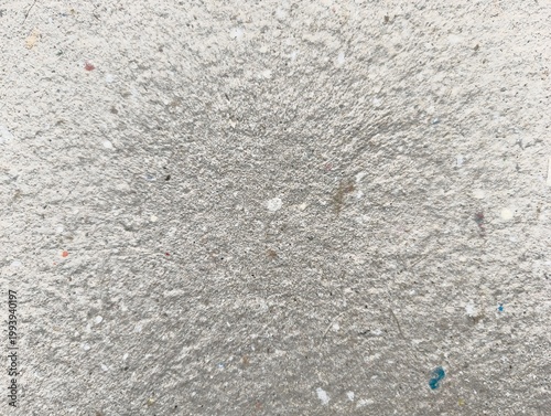 A rough grey cement material surface with an old grunge concrete wall texture and a dark granite stone pattern creates a textured rock background design
