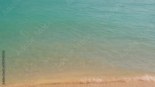 Tranquil coastal scene gentle waves meeting sandy shoreline