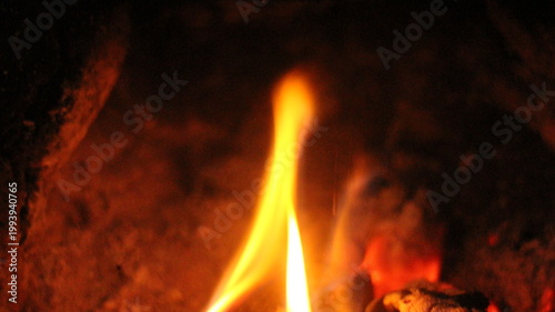 фотографія Close up of burning wood logs blazing in flames inside black wrought iron wood burning fire