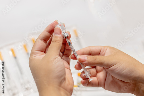 Vials of Tirzepatide medication and insulin syringes for weight loss and diabetes treatment.
