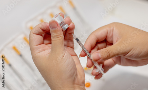 Vials of Tirzepatide medication and insulin syringes for weight loss and diabetes treatment.