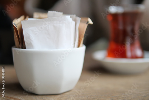 Schilderij op canvas Coffee shop setting with sugar packets on a table