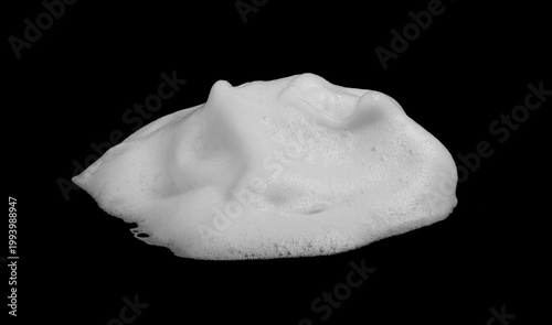 White foam texture isolated on black background, soft soap bubbles with creamy surface and airy structure. Clean abstract foam pattern ideal for hygiene, skincare, cleaning product ads