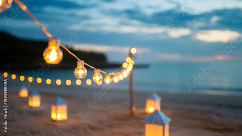 Warm string lights and lanterns on a serene beach at dusk with a calm sea and cloudy sky