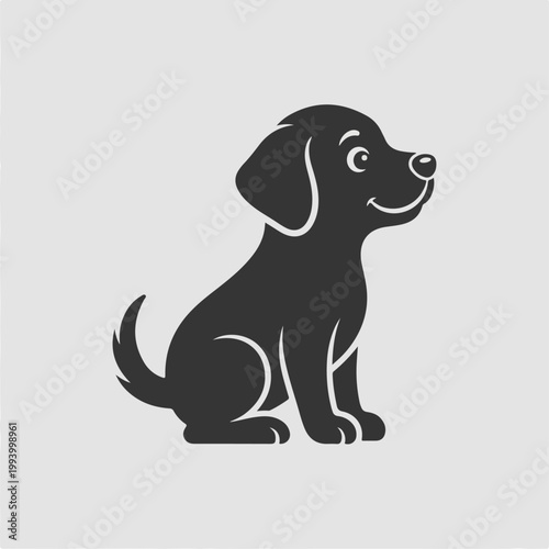 Black dog sitting and looking up.