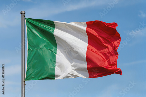 Italy flag fluttering in the blue sky