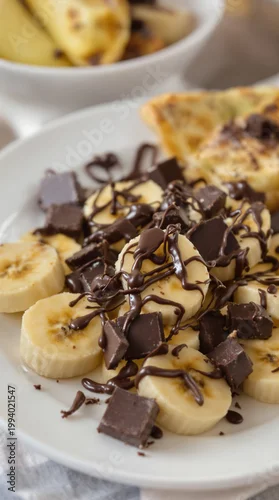 Panel kuchenny z motywem girl dinner banana chocolate snack plate with caramel drizzle and crushed nuts on marble table