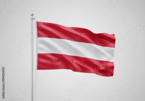 Waving flag of austria on a flagpole against a plain background