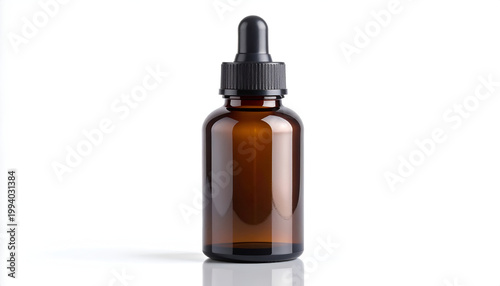 Amber glass bottle with black dropper cap for essential oils or serum on white background in studio shot for beauty products