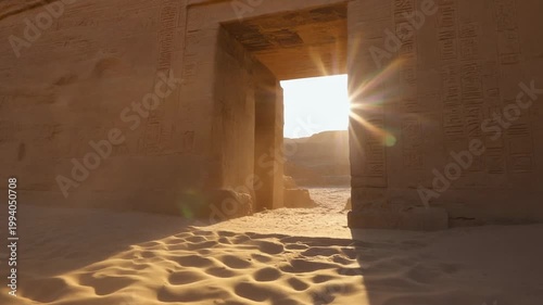 Sunlight filters through ancient desert temple entrance with sandy floor