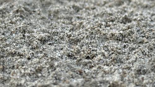Photos Close up view of coarse textured gray sand or tiny gravel creating an interestin