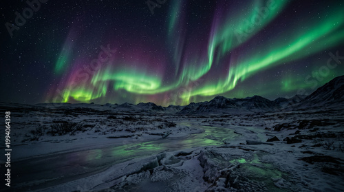 Vibrant northern lights over snow covered arctic mountains and icy river