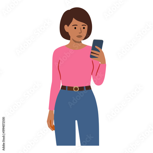 A woman wearing a pink shirt looks at her phone with concern indoors.