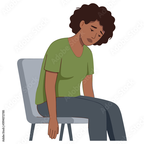 A woman sits on a chair with her head down in sadness and despair.