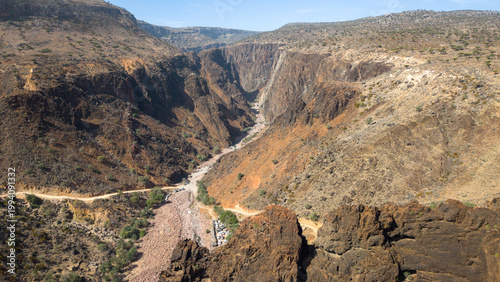 Panoramic rugged canyon with dry riverbed and steep cliffs. Wadi Dirhur, Sokotra, Yemen.