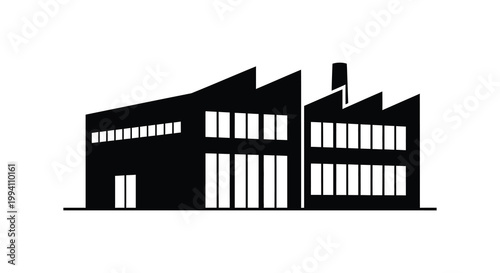 A stark black industrial building with a chimney presented as a silhouette