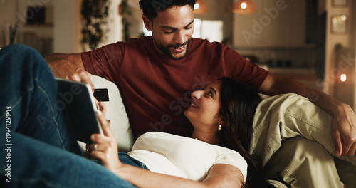 Fotografie Couple, relax and credit card on sofa with tablet, digital payment or online shopping for anniversary