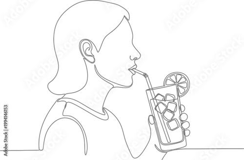 A person enjoys a refreshing beverage with ice and a citrus garnish through a straw.