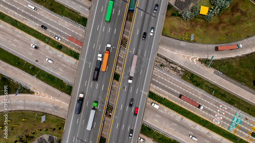 Aerial top view symmetrical highway interchange crossroad highway junction, Highway intersection with traffic intersection, Interchanges elevate transportation highway intersection road express way.