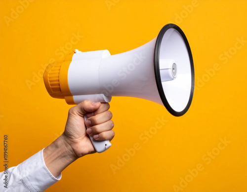 Hand holding white and orange megaphone