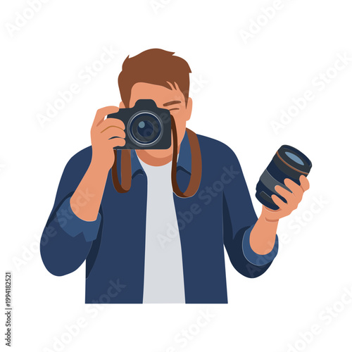 A man holds a camera and lens while taking a photo indoors.