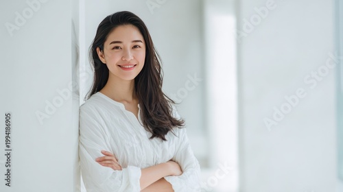 Radiant Smile of a Woman: A young woman with a genuine smile leans gracefully against a neutral-toned wall, exuding a sense of contentment and peace. This portrait embodies the purity of inner joy. Free Download Radiant Smile of a Woman: A young woman with a genuine smile leans gracefully against a neutral-toned wall, exuding a sense of contentment and peace. This portrait embodies the purity of inner joy. - GFXLoad