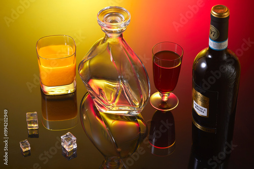 Still life with decanter,bottle and two glasses  with wine and liquor