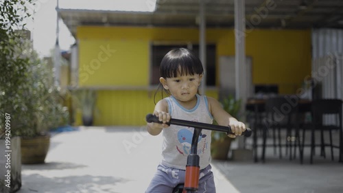 Little Child Learning Balance Bike Riding Practice, A video of little child practicing balance bike, capturing early determination and growth, perfect for child development documentary and toy.