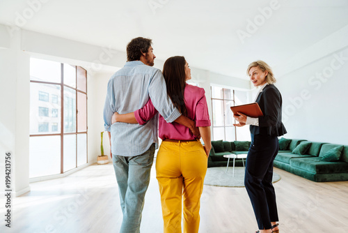 Real estate agent showing an apartment to a couple.