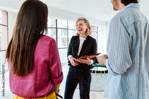Real estate agent showing an apartment to a couple.