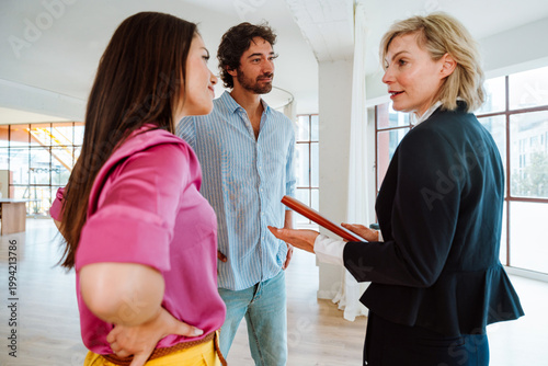 Real estate agent showing an apartment to a couple.