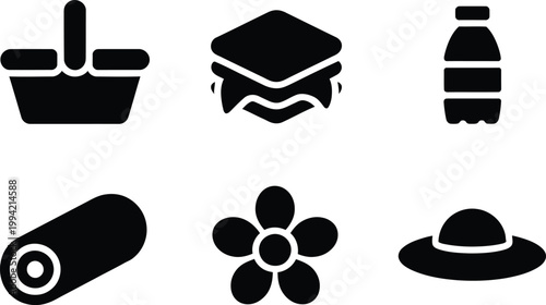 Picnic set with basket, sandwich, water bottle, blanket roll, flower, and sun hat