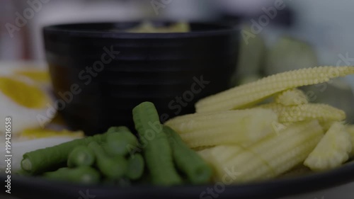 Nam Prik Num Fresh Vegetables On Plate Thai Food, A motion picture of Nam Prik Num served with fresh vegetables, showcasing authentic Northern Thai flavors, for food documentary and culinary.